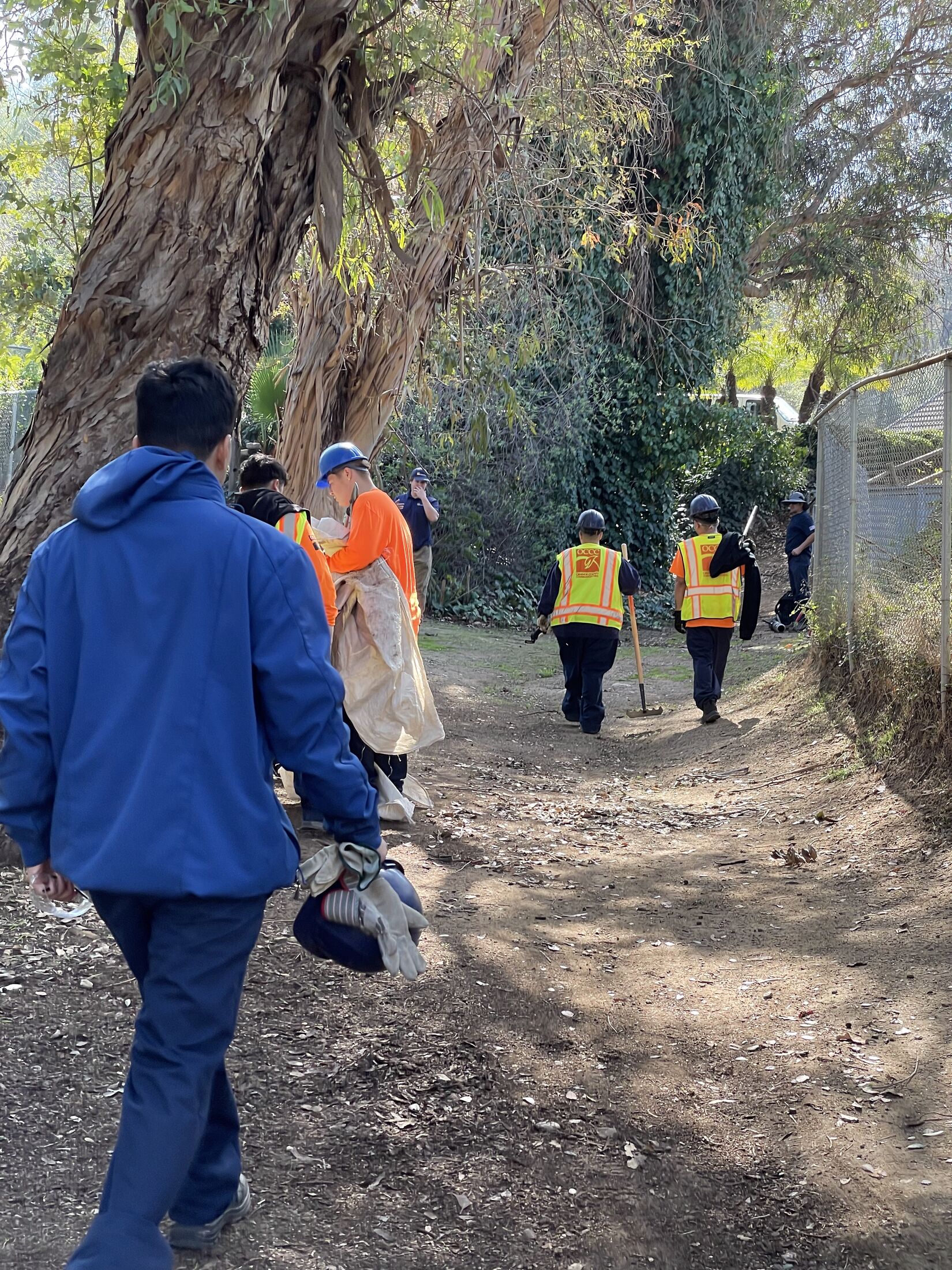 OCCC field crew walking a tree-shaded trail